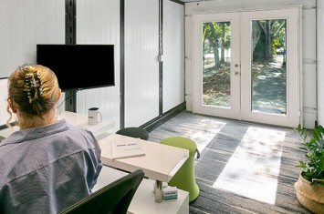 Worker at desk inside Cool-Binz mobile office