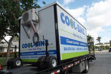 cool binz climate controlled insulated storage container with wheels attached sitting on top of a flatbed truck