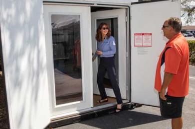 cool binz employee opening the door to the insulated storage container for a customer