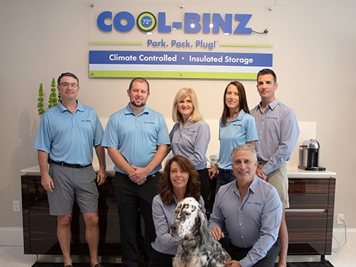 indoor office shot of cool binz team in front of company logo with dog