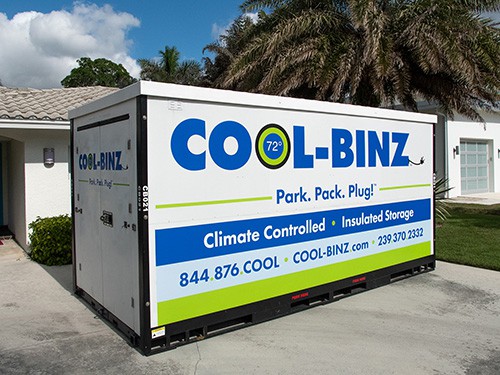side profile of a cool binz storage container parked in the driveway on the side of a residence