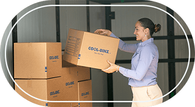 Woman placing box inside rental storage bin