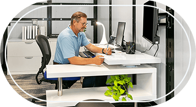 Man at desk inside climate controlled bin