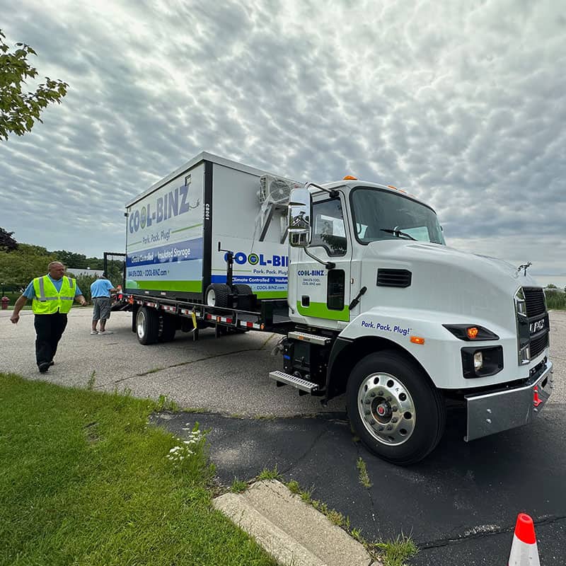 Technicians delivery a refrigerated portable bin