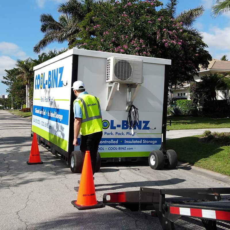 A COOL-BINZ worker standing by a climate controlled bin with traffic cones around